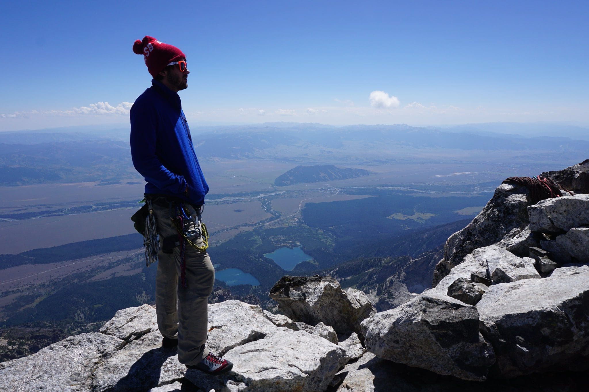 Male climber overlooking the valley below the Tetons